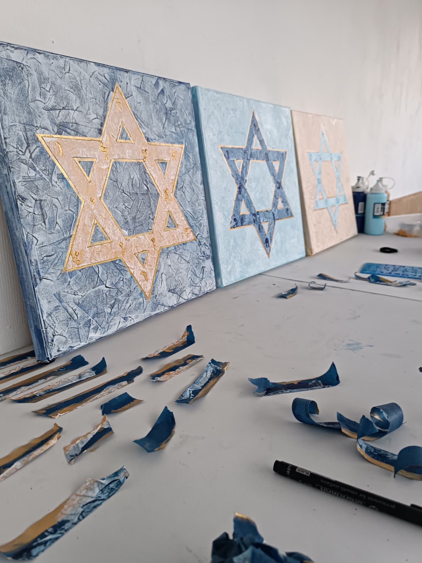 Three Magen David canvases on the studio table